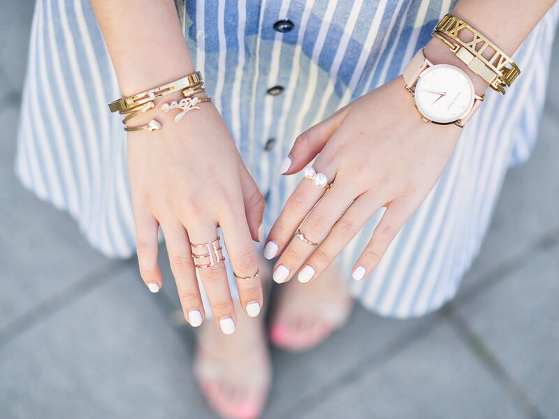 gold rings and bracelets, white nails