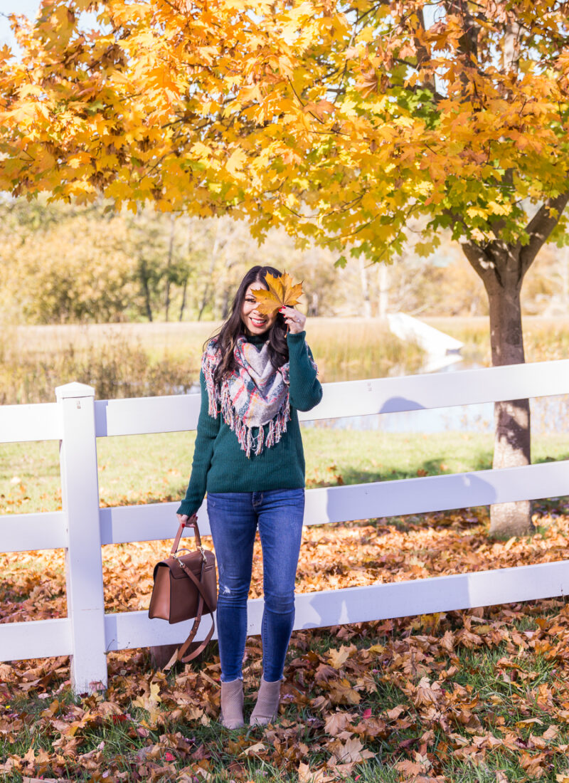 Just A Tina Bit blogger wearing Free People bandana scarf, BP funnel neck sweater, Steve Madden booties, and Cuyana top handle bag, casual fall outfit, San Juan Islands Friday Harbor, fall foliage with white fence, leaf in eye photo