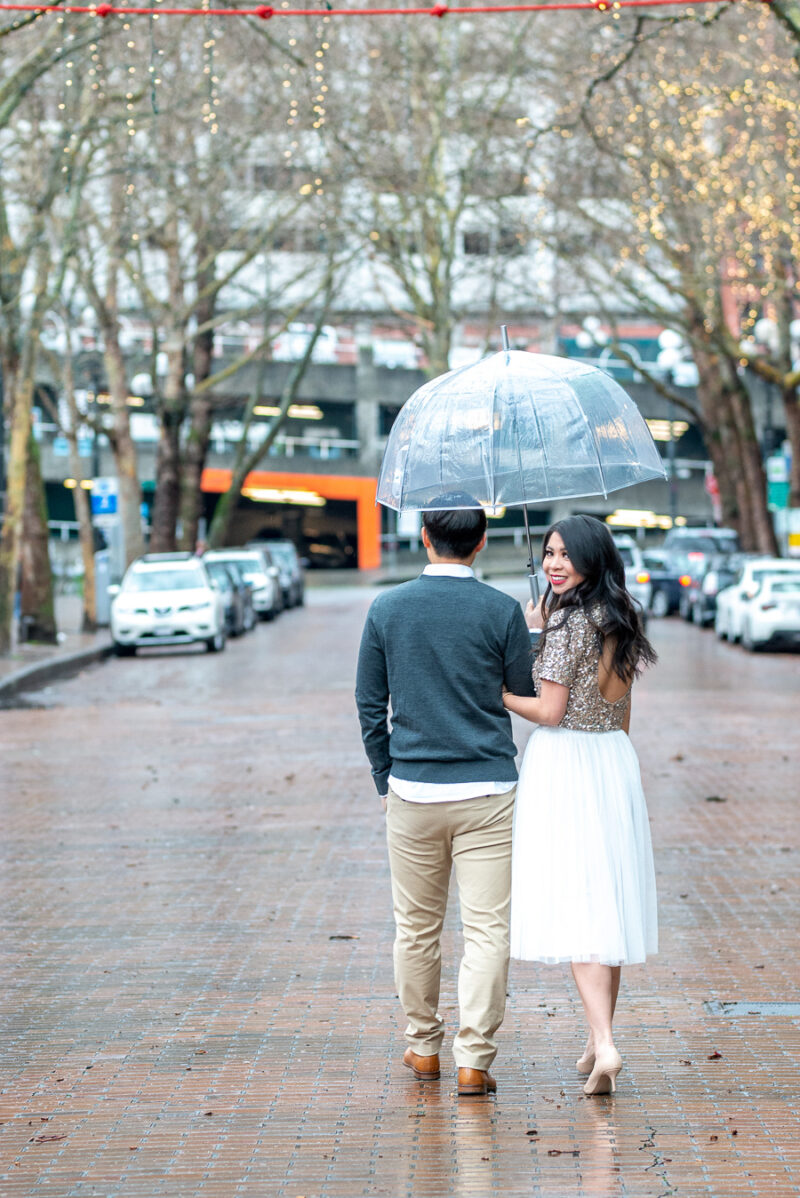 Seattle engagement photos in Pioneer Square, Occidental Park, holiday shoot, rainy engagement photos with clear umbrella, Seattle fashion blogger Just A Tina Bit