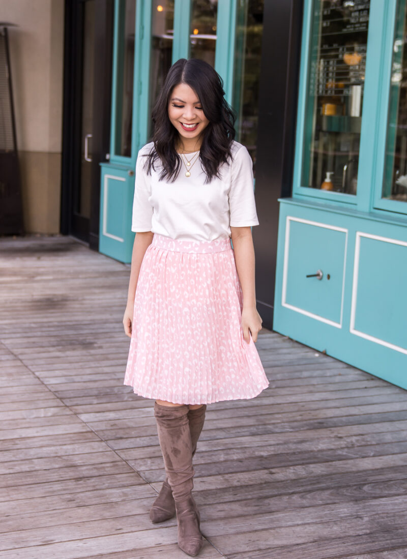 Seattle fashion blogger from Just A Tina Bit wears a leopard pleated skirt with a white top tucked into the skirt and Steve Madden over the knee boots, top and skirt are from Gibson Look International Women's Day collection, spring transition outfit, spring style