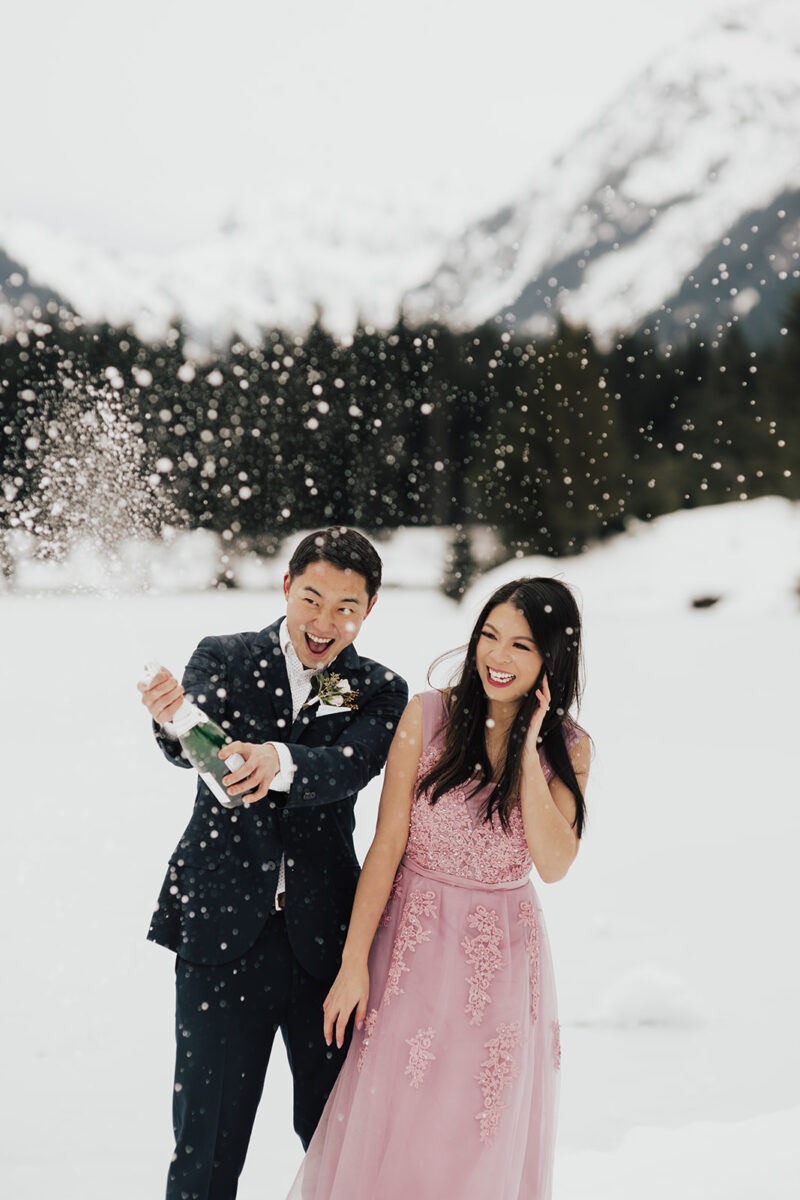 Winter formal engagement photos at Gold Creek Pond in Snoqualmie, Washington, snow photo shoot session, pink blush gown, affordable engagement gown from Amazon, engagement bouquet, engagement shoot outfits, engagement champagne popping photo