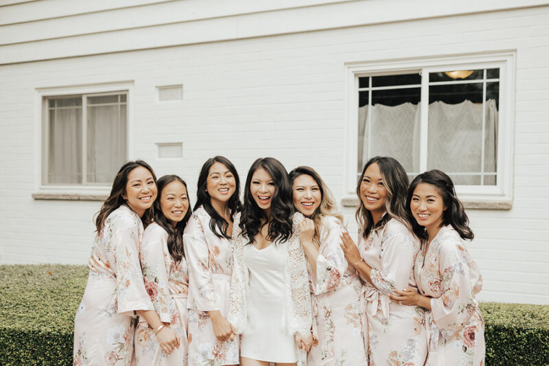 Seattle outdoor wedding at Rock Creek Gardens, wedding getting ready photos wearing floral robes from BHDLN, mauve floral robes, bridal white lace robe with silk chemise, wedding outfits, wedding blogger, Vietnamese American wedding