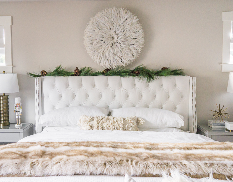Master bedroom Christmas decorations, white tufted bed, juju hat, garland bed, flocked Christmas tree, holiday home tour, Seattle home decor blogger, neutral bedroom