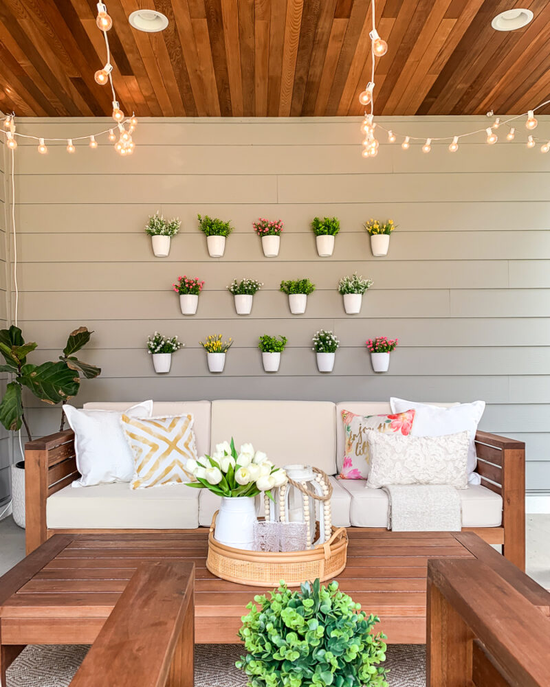 DIY plant wall decor for patio, outdoor design, faux flowers in hanging white pots, easy project for outdoor design
