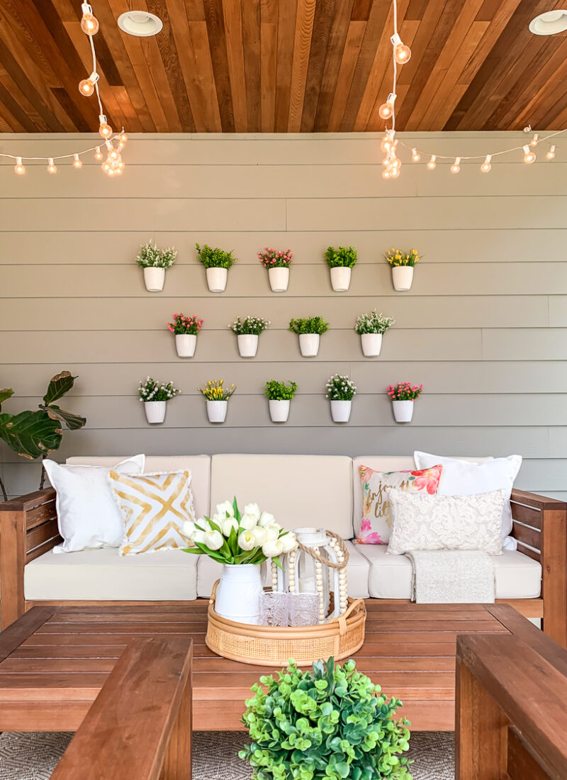 DIY plant wall decor for patio, outdoor design, faux flowers in hanging white pots, easy project for outdoor design