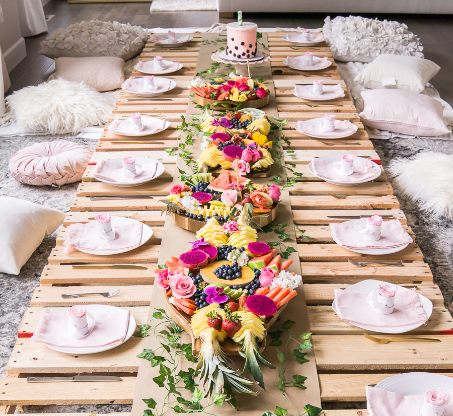 Picnic bridal shower with wood pallets, exotic fruit platters, table setting with mini rose boxes as party favors