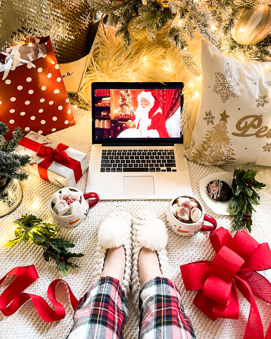 10 VIRTUAL HOLIDAY PARTY IDEAS FOR THE WHOLE FAMILY - virtual movie night, movie on laptop, hot cocoa, pom slippers, cozy home, plaid pjs from Old Navy