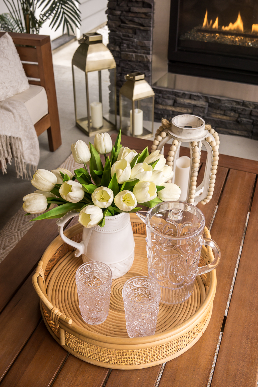 Faux tulips in white pitcher, outdoor drink tray