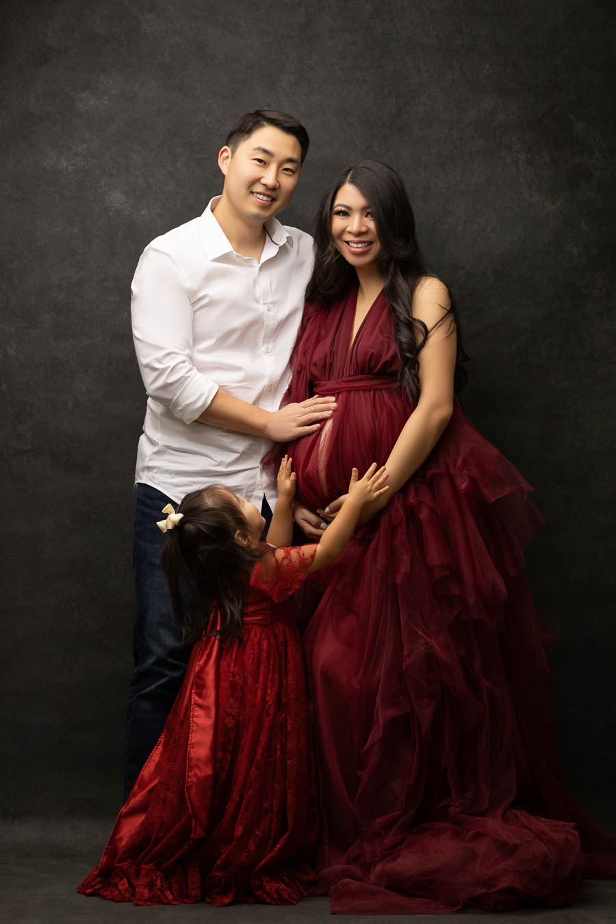 family maternity photo shoot in studio, burgundy tulle dress, seattle maternity photography