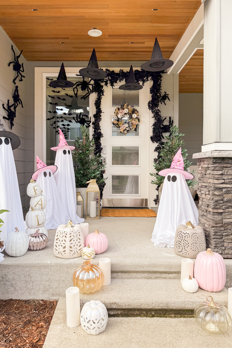 Halloween front porch with pink witches hats and ghosts
