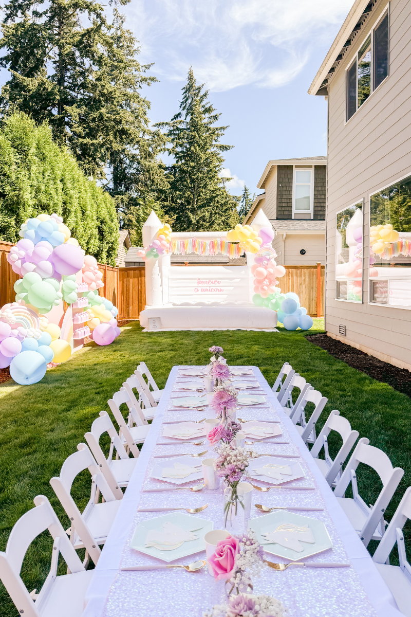 Unicorn Birthday Party, white bounce house, unicorn napkins, pastel paper plates, iridescent tablecloth, fourever a unicorn theme, 4th birthday party