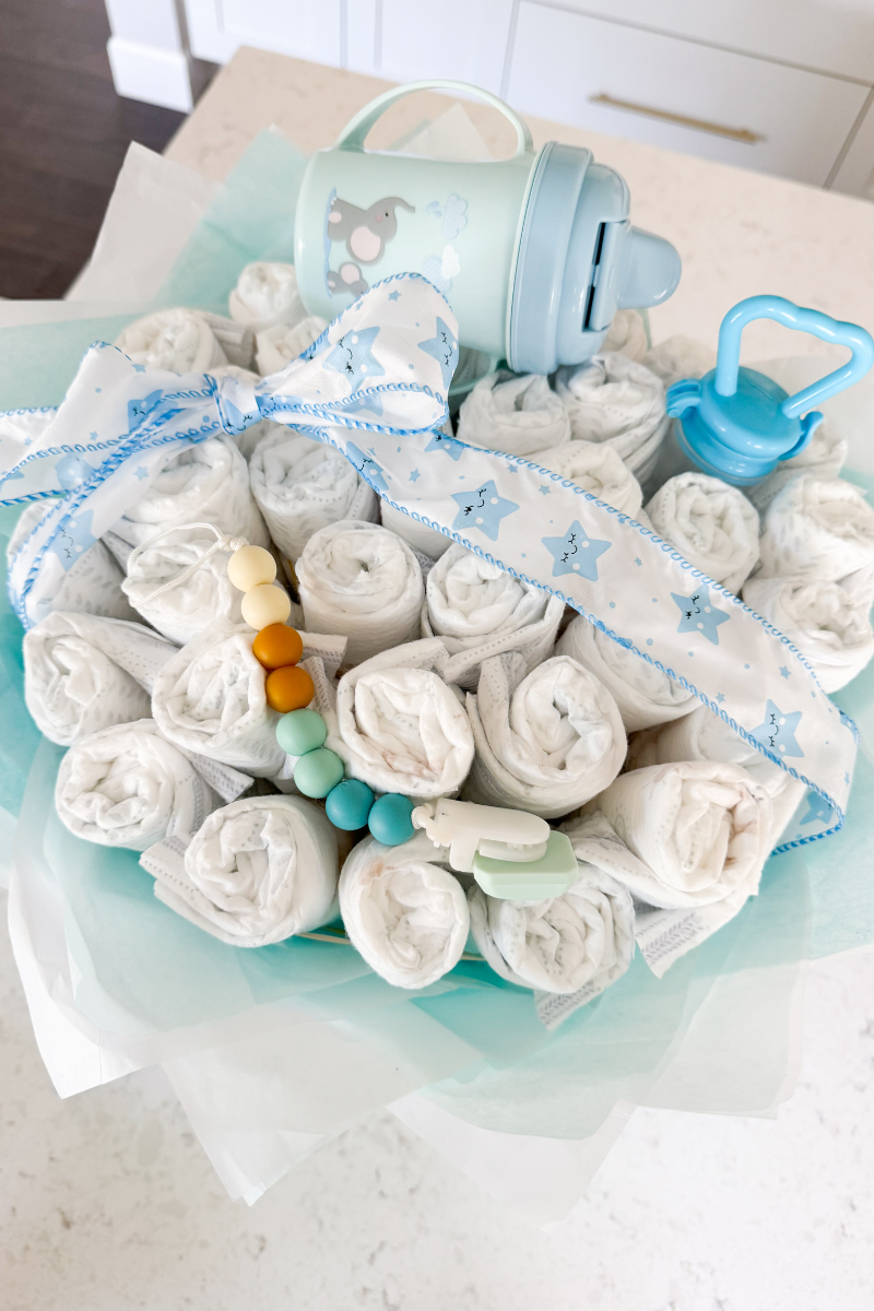 Diaper bouquet gift for baby shower with cute finishing touches