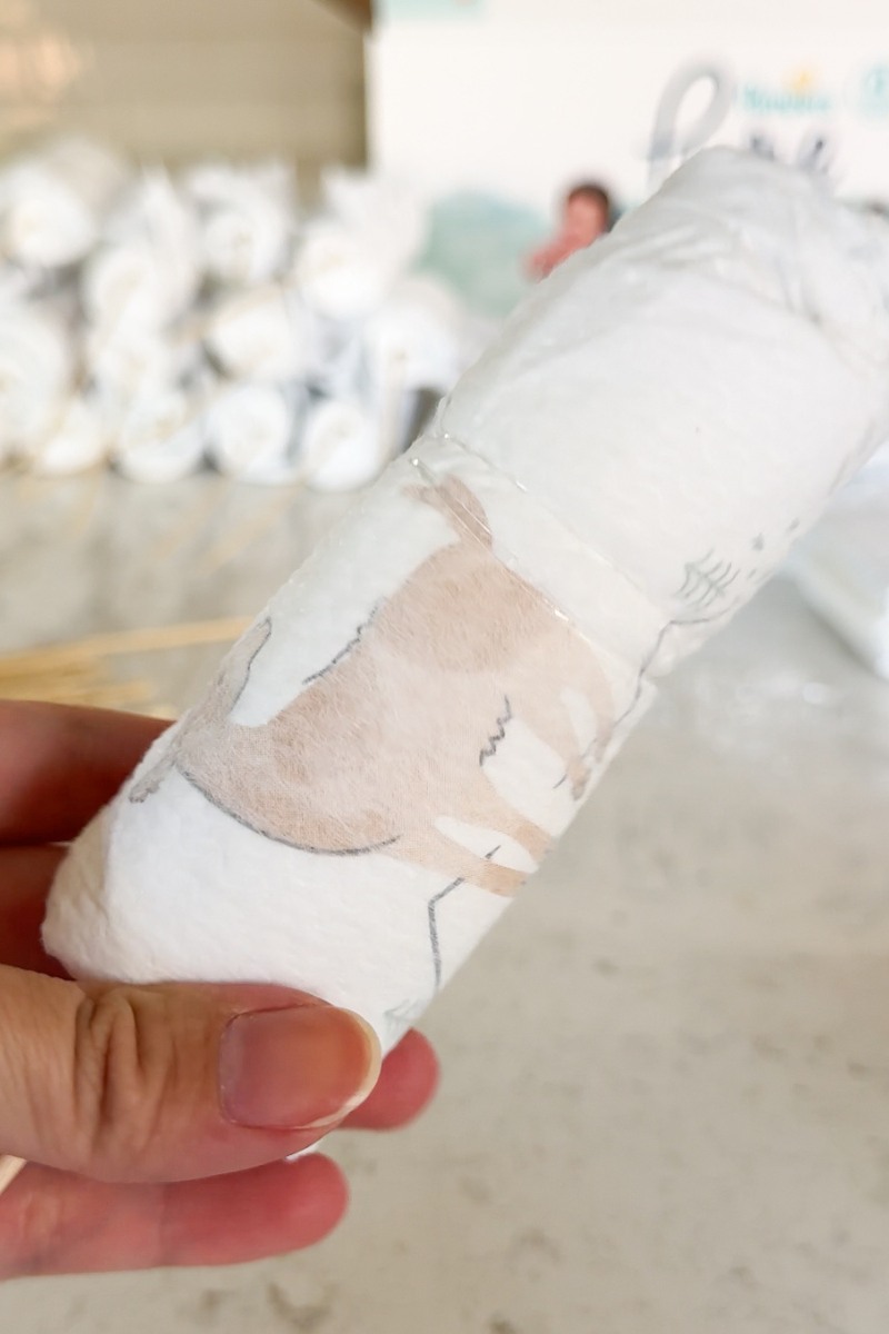 diaper bouquet tutorial - rolled diaper secured by elastic band